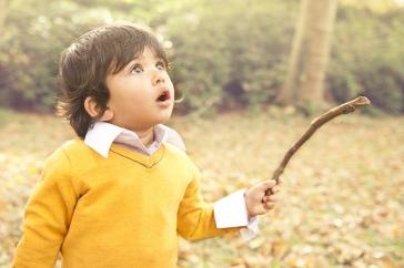 boy outside, looking up in wonder