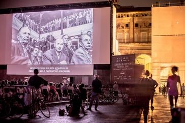 film screening outside in Bologna with large audience watching